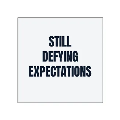 STILL · DEFYING · EXPECTATIONS in White